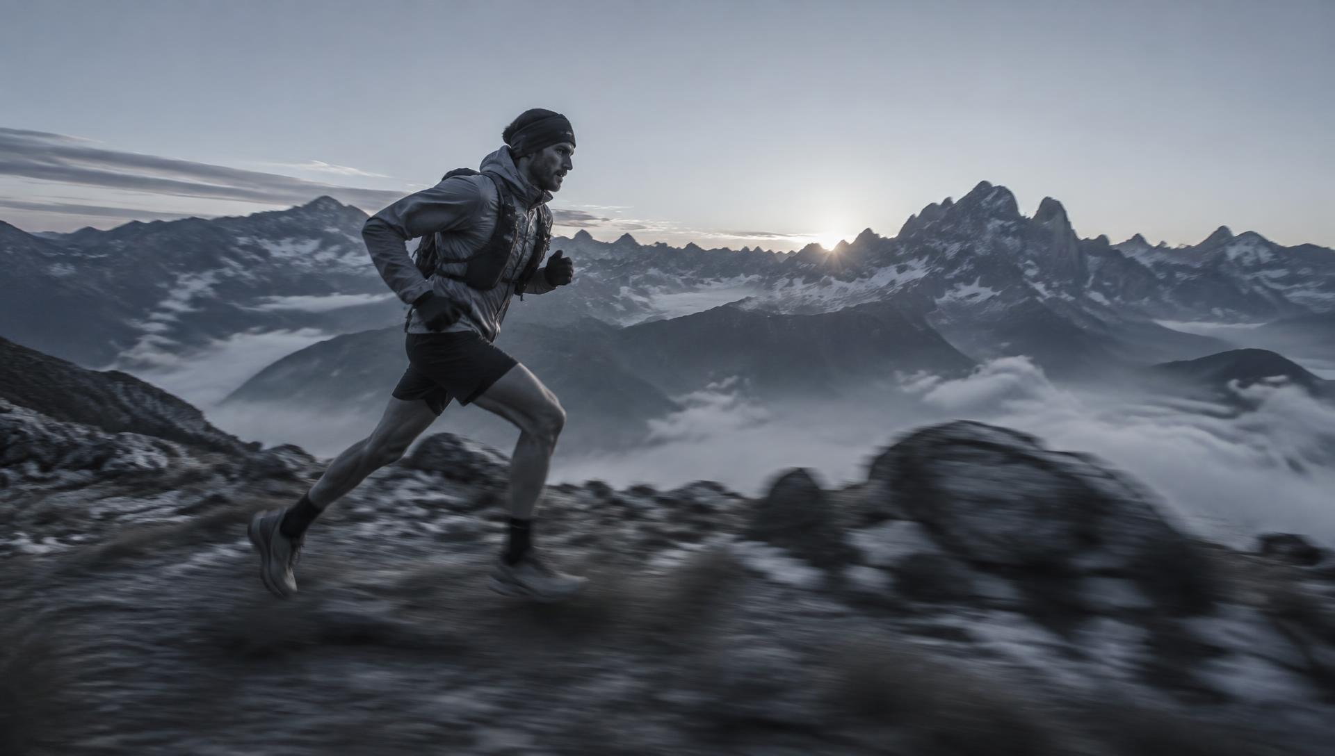 Trail runner at speed on an alpine ridge at dawn